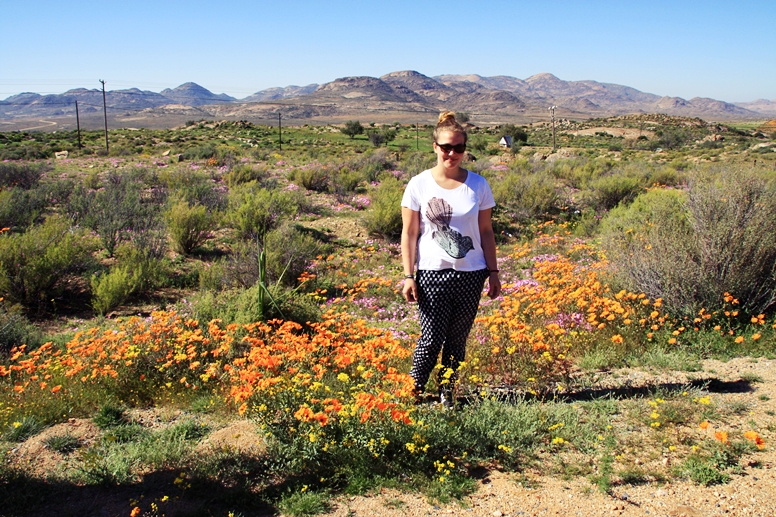 Lynn steht mitten in dem Blütenmeer im Namaqualand