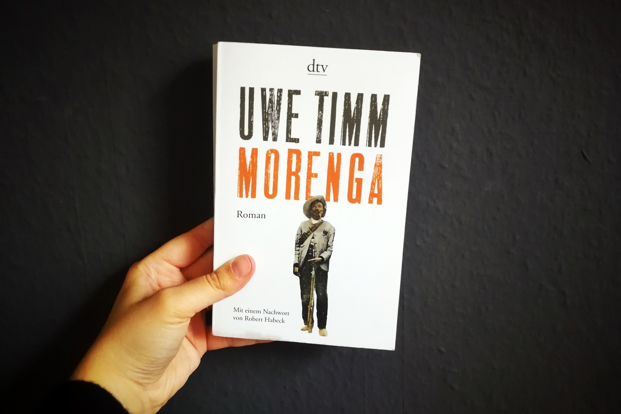Hand die das Buch Morenga von Uwe Timm hält