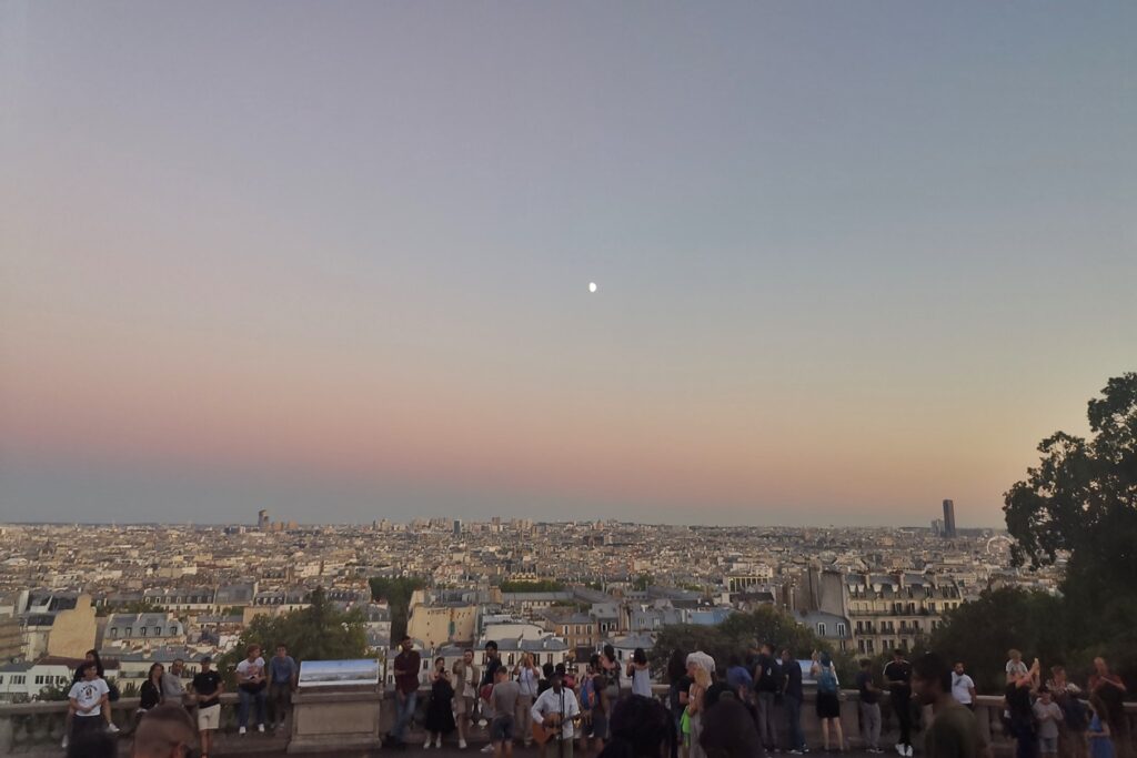 Blick von Montmartre auf Paris und Straßenmusiker zur blauen Stunde
